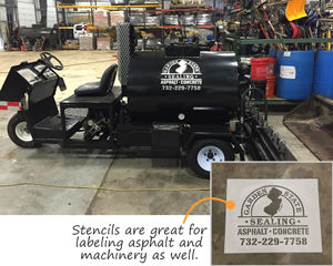 Custom stencils on asphalt and machinery