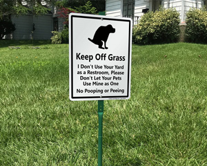 Dogs keep off of the grass signs
