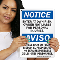 Enter At Own Risk Bilingual Sign