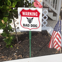 Caution: Bad dog on property lawn boss sign